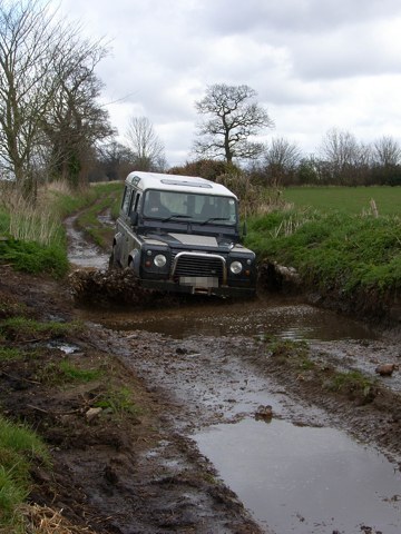 Land Rover in muddy Norfolk lane